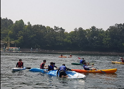 마산 앞바다에서 카약을 체험하고 있는 사진으로 카약은 스스로 노를 저어 체험할 수 있는 장비이며 별도 교육이 필요 없으므로 노를 저을 수 있다면 누구나 이용 가능한 장비입니다.